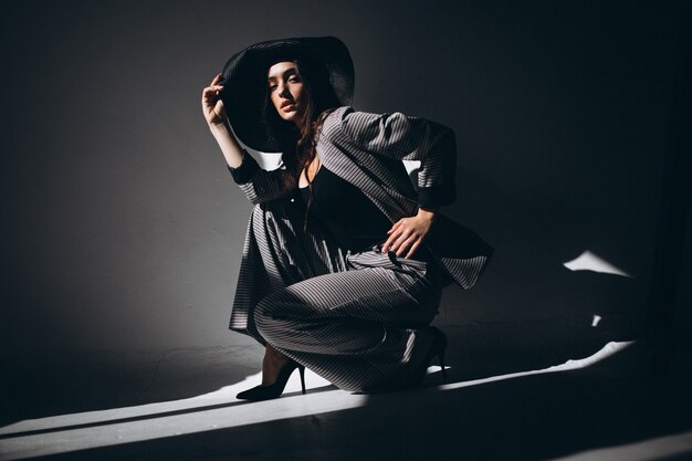 Woman model in a business suit wearing a hat