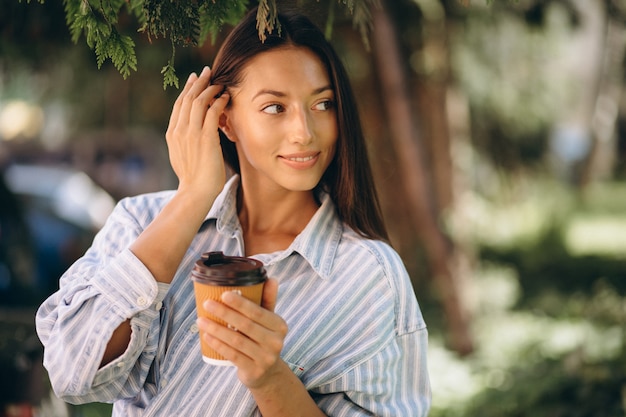 Woman model in man shirt drinking coffee