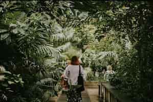 Free photo woman, moody nature photo, aesthetic greenhouse