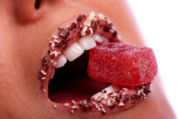 Woman mouth with colored candy