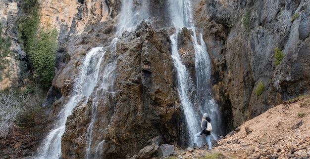 Woman in nature at waterfall
