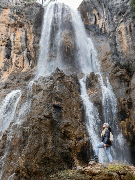 woman in nature at waterfall