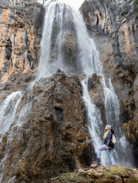 Woman in nature at waterfall