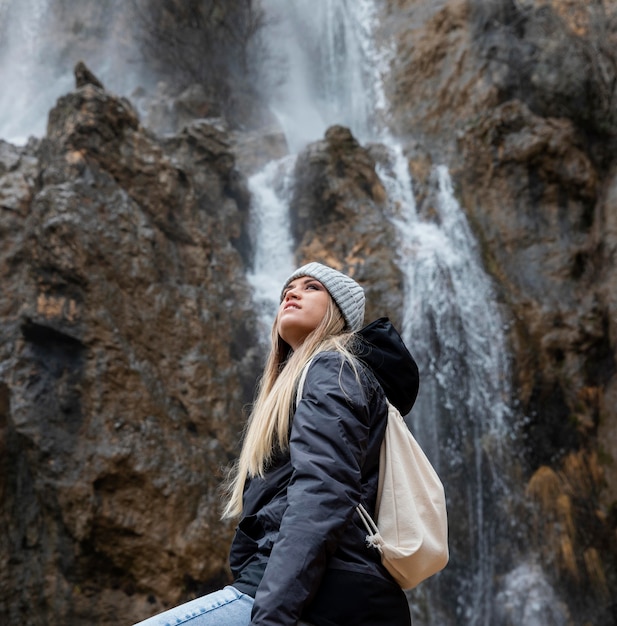 Woman in nature at waterfall