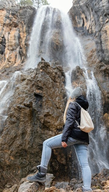 woman in nature at waterfall