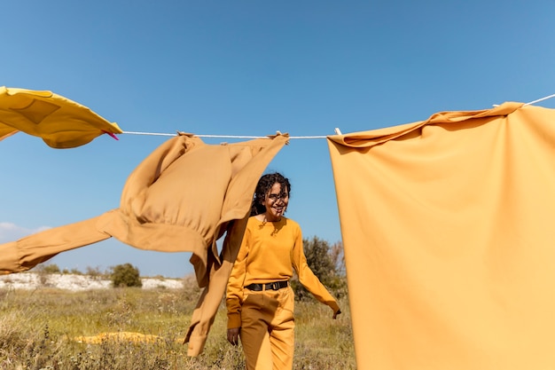 Free photo woman in nature with clothesline