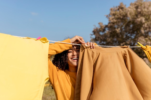 Free photo woman in nature with clothesline
