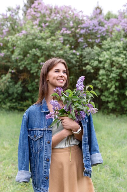 Woman in nature with lilac branches