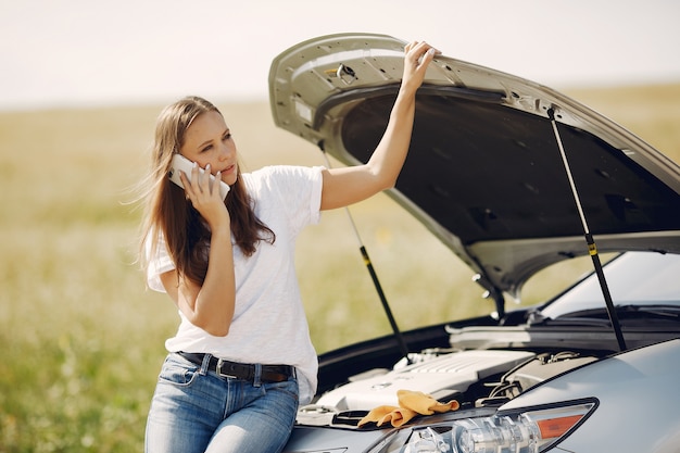 Free photo woman near broken car call for help