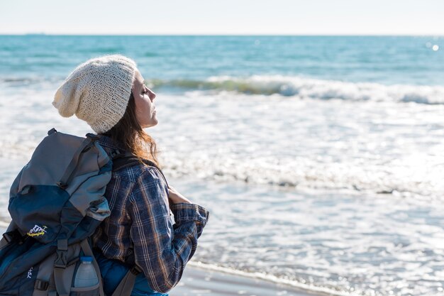 Woman near ocean enjoying breeze