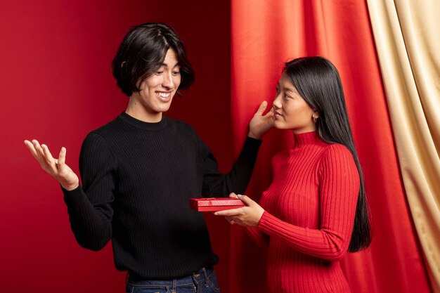 Woman offering gift to man for chinese new year