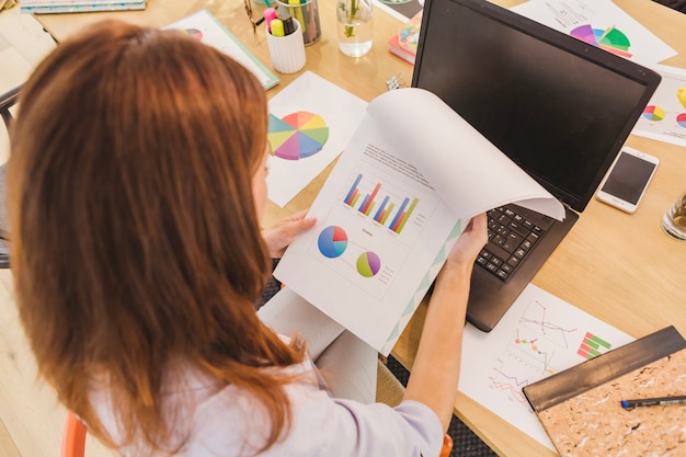 Free photo woman in office exploring statistics