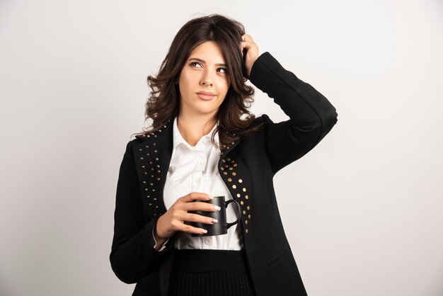 Woman office worker posing with cup of tea