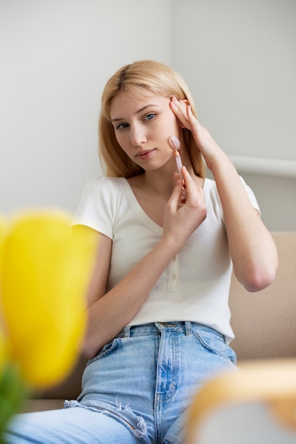 Woman ongoing gua sha face procedure