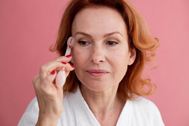 Woman ongoing gua sha face procedure