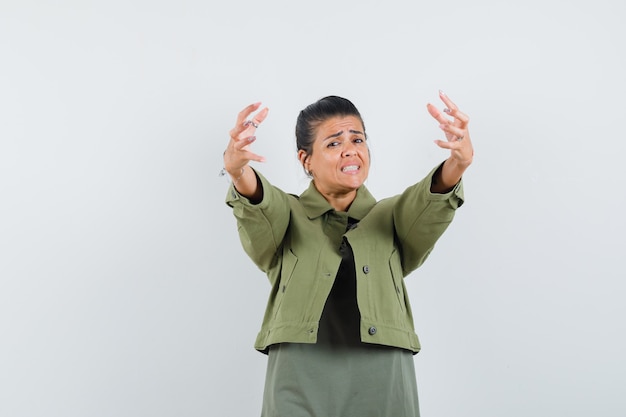 Free photo woman opening arms for hug in jacket, t-shirt and looking excited.