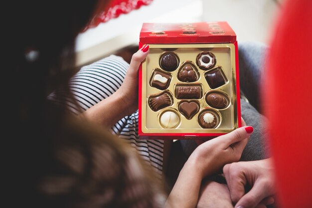 Woman opening a box of chocolates