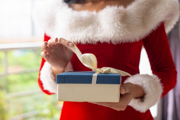 Woman opening Christmas gifts