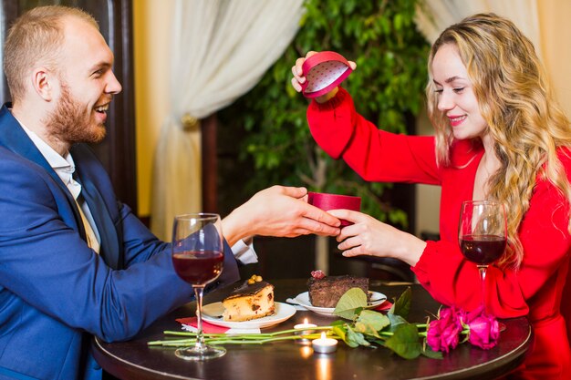 Woman opening gift box at table 