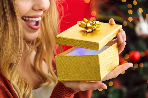 Woman opening a golden gift