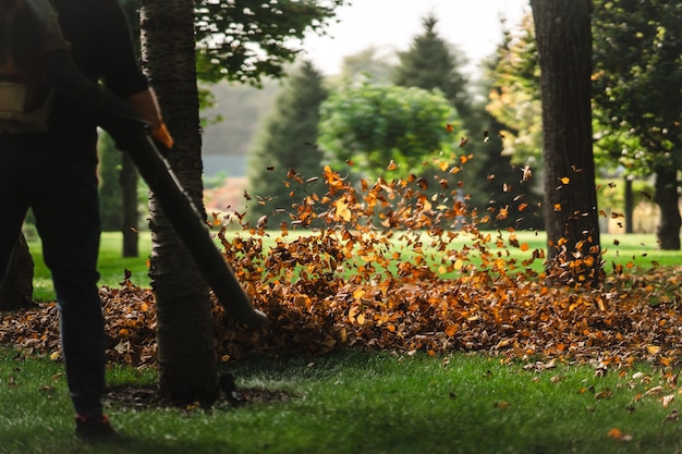 A woman operating a heavy duty leaf blower