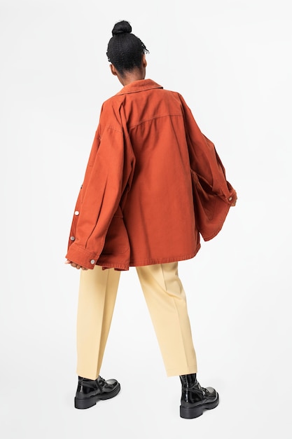Free photo woman in orange oversized jacket street style apparel rear view