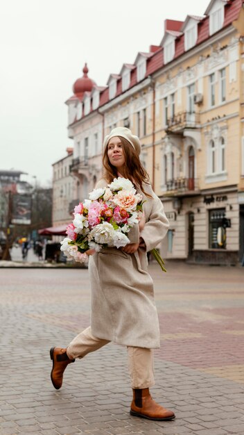 Woman outdoors holding bouquet of flowers in the spring