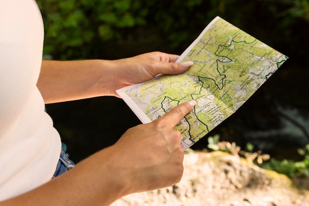 woman outdoors in nature with map
