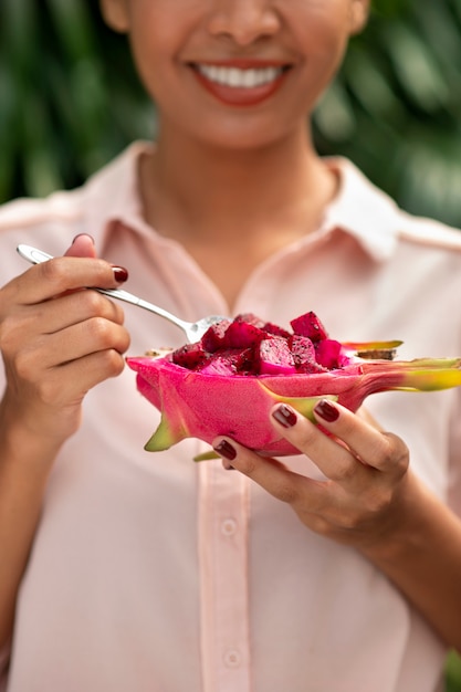 Woman outdoors with dragon fruit