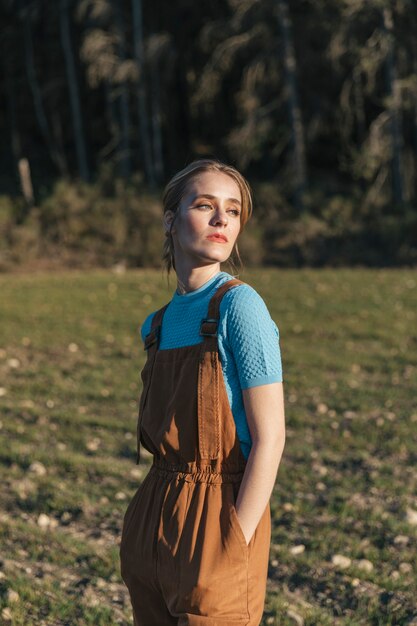 Woman in overall looking sideways