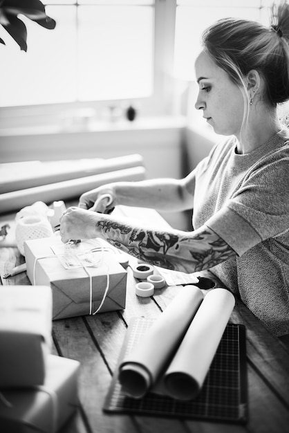 Woman packing parcel box by herself