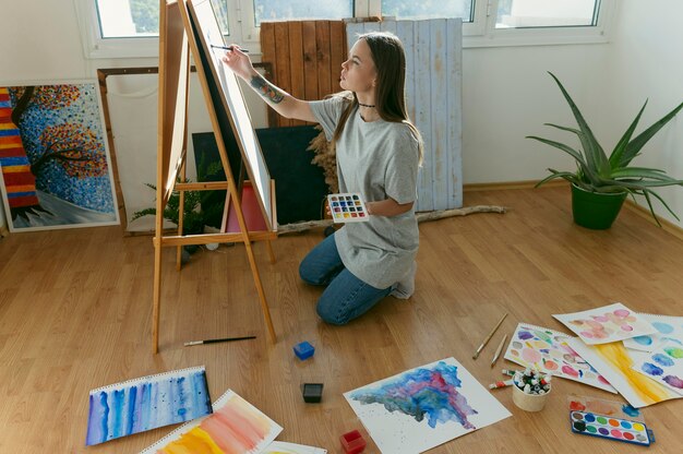 Woman painter sitting on the floor