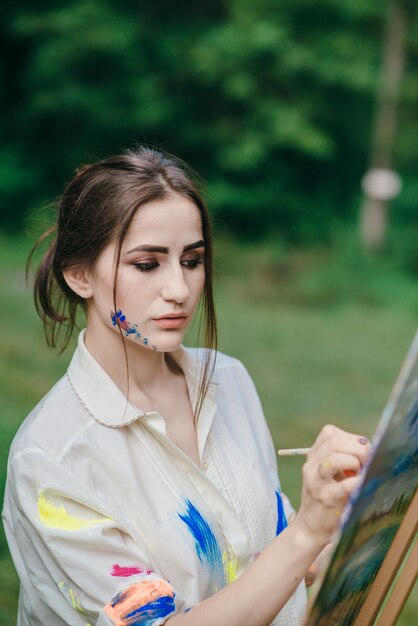 Woman painting on a canvas