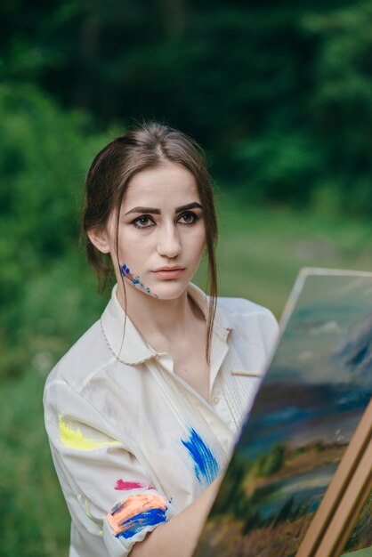 Woman painting on a canvas