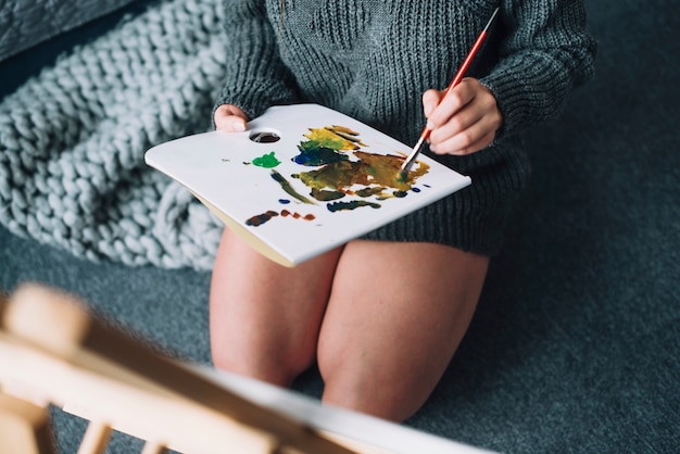 Woman painting on floor