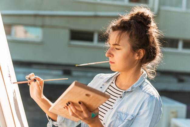 Woman painting outdoors