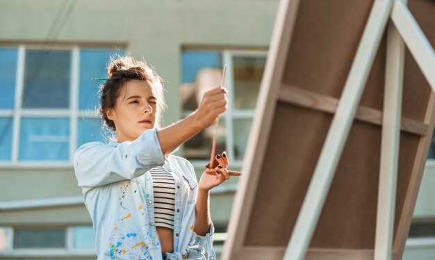 Woman painting outdoors