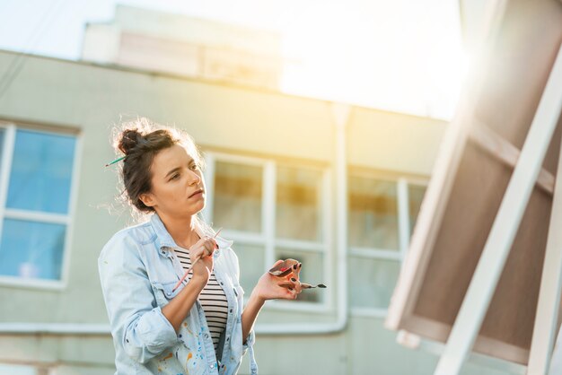 Woman painting outdoors