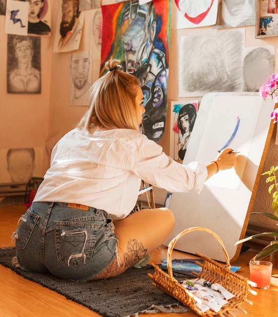 Woman painting with watercolor in studio
