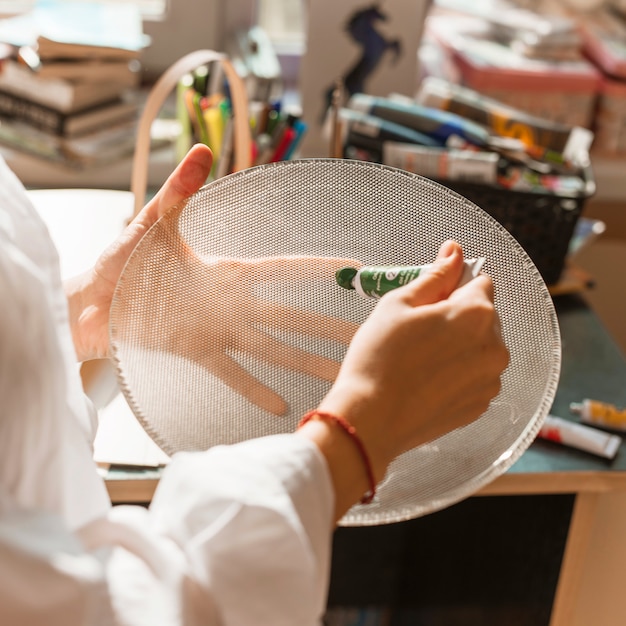 Free photo woman painting with watercolor in studio