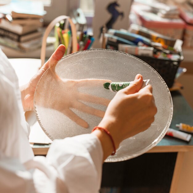 Woman painting with watercolor in studio