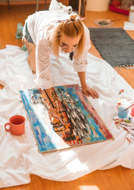 Woman painting with watercolor in studio