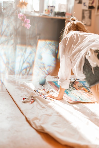 Woman painting with watercolor in studio