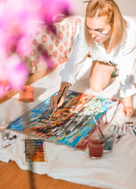 Woman painting with watercolor in studio
