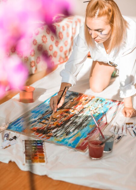 Woman painting with watercolor in studio