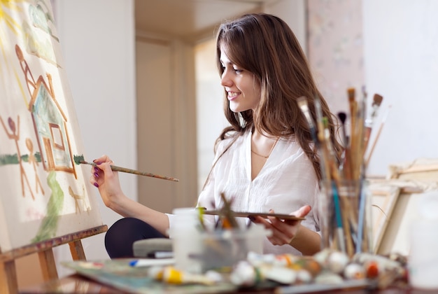 woman paints on canvas