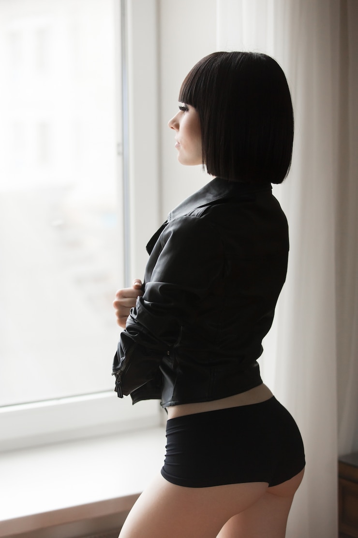 Free Photo woman in panties looking out the window
