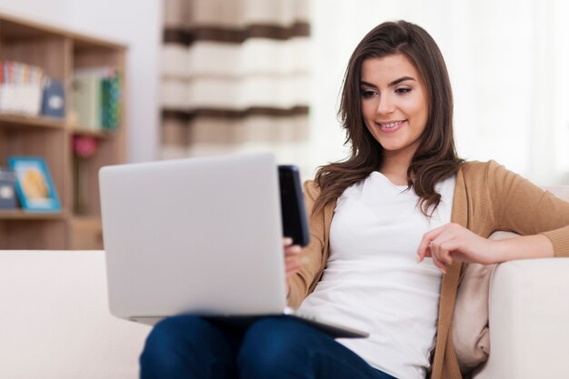 Woman paying by qr code at home