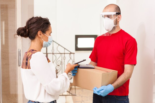 Woman paying with phone app courier services.