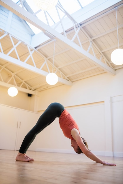 Woman performing downward dog exercise